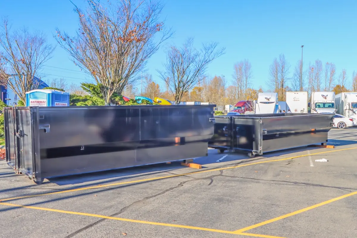 Professional dumpster rental service with roll-off container on residential driveway in Dunbar